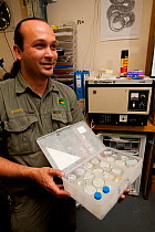 Roberto Bolanos, snake keeper, with vials of venom, used in medical research and for making anti-venom. Australian Reptile Park, Gosford, New South Wales.