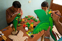 Frandi Rodriguez, sculptor and painter, making yellow-eared parrot models with helpers. Roncesvalles, Tolima, Colombia, 2010.
