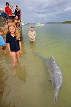 Children observing a habituated Australian humpback dolphin (Sousa sahulensis). Tin Can Bay, Queensland, Australia, September.