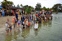 Tourists at dolphin feeding point. Tin Can Bay, Queensland, Australia, September.