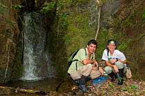 German Corredor and Catalina Silva, biologists surveying for poison dart frogs. Cauca Valle Dagua, Cali, Colombia, January 2010.