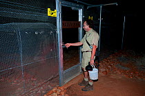 Anthony Molineux locking the predator fence at the marsupial reserve. Desert Park, Alice Springs, Northern Territory.