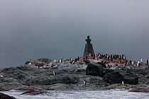Elephant Island, with penguins surrounding memorial at Point Wild to Captain Luis Pardo Villalon of Chilean ship, The Yelcho, which on 30 August 1916 rescued Shackleton's party left on Elephant Island...
