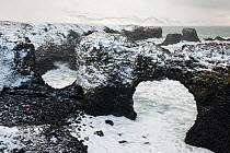 Gatklettur arch and Arnarstapi sea stacks in winter storm, Snaefellsnes Peninsula, Iceland, February 2011