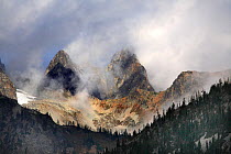 The rocky highlands of North Cascades Range above the tree line in clouds, on Maple-Loop Trail in Rainy Pass area, North Cascades National Park, Cascade Range, Washington, October 2009.