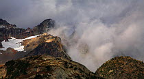 The rocky highlands of North Cascades Range above the tree line in clouds on Maple-Loop Trail in Rainy Pass area, North Cascades National Park, Cascade Range, Washington, October 2009.