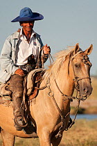 A cowboy riding his Quarter mare, Estancia Don Amerigo, Chaco, Paraguay, January 2012
