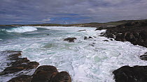 Waves breaking on rocky shore, North Uist, Outer Hebrides, Scotland, UK, May