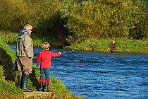 Family fishing from the bank of the River Tweed at Junction Pool, Kelso, Roxburghshire, Scotland, UK, October 2011. 2020VISION Exhibition. 2020VISION Book Plate. Did you know? The most popular UK spor...
