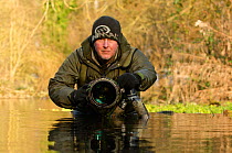 Photographer Terry Whittaker photographing Water voles (Arvicola terrestris) whilst on assignment for 2020VISION, Kent, England, UK, February 2012. 2020VISION Exhibition.