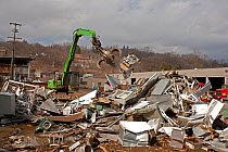 Fridges and various other metals in a large pile with machinery at Recycling Center, Ithaca, New York, USA, property released.
