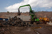 Machinery lifting tyres, Recycling Center, Ithaca, New York, USA, property released.