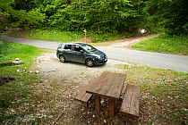 Car parked in woodland, used by photographer for meet your neighbour project, Savoie, France, June 2011. meetyourneighbours.net project