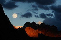 Full moon at sunset over the mountains of the Zanskar region, Himalayas, Jammu and Kashmir, India, September 2011