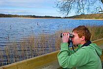 Boy birdwatching at Ormesby Little Broad, Trinity Broads, Norfolk Broads, Norfolk, UK, April 2012