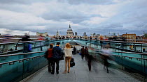 Timelapse of people crossing the Millennium Bridge towards St. Paul's cathedral, London England, UK, September 2011.