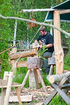 Volunteers working wood at the Birmingham EcoPark, a Black Country Living Wildlife Trust education centre in Small Heath, West Midlands, July 2011. Model released.