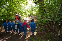 Children from Rowley View Nursery School walking in woods at the Moorcroft Environmental Centre Forest School, Moorcroft Wood, Moxley, Walsall, West Midlands, July 2011. Model released.