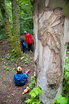 Children from Rowley View Nursery School playing in woodland at the Moorcroft Environmental Centre Forest School, Moorcroft Wood, Moxley, Walsall, West Midlands, July 2011. Model released.