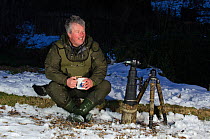 2020VISION Photographer Terry Whittaker drinking tea whilst having a break from photographing water voles (Arvicola terrestris), Kent, England, UK, February 2012. Model released.