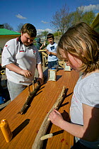 Volunteer chikdren making useful items as part of skill learning course at community city farm, Swansea, Wales, April 2009.