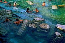 People bathing in hot springs pool, Ancient city of Hierapolis, Pamukkale, near Denizli, Turkey, July 2006