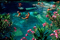 People bathing in hot springs pool, Ancient city of Hierapolis, Pamukkale, near Denizli, Turkey, July 2006