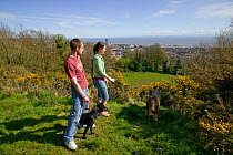 Couple with dogs overlooking Rosehill Quarry Community Park, importance of greenspace in city, Swansea, Wales, UK 2009