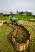 Young volunteers help create raised planting beds for growing food, Down to Earth environmental project, Murton, Gower, South Wales, UK 2009