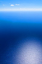 Aerial image showing light reflected off the deep blue of the sea around the Bahamas archipelago, Caribbean, February 2012