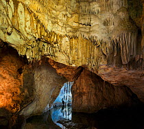 Stalactites and deeply fluted formations with turquoise waters of an unnamed Cenote near Merida, Yucatan, Mexico