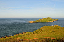 Overview of the Worm's head cut off from the mainland as an island at high tide, Rhossili, The Gower peninsula, Wales, UK, July. Sequence 2 of 2, matching views at different tides
