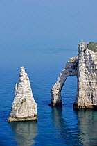 The sea stack L'Aiguille and the Porte D'Aval, a natural arch in the chalk cliffs at Etretat, Côte d'Albâtre, Upper Normandy, France, March