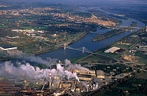 Aerial view of River Rhone at Beaucaire with pollution from factory producing paper paste, Camargue, France