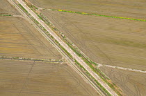 Aerial view of old railway line crossing dry rice fields, Camargue, Southern France, May 2009