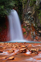 Red rocks coloured by the geothermal waters at Pulangbato Falls on Negros, The Visayas, Philippines