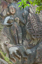 Archeological site (7th- 9th century) and Shiva pilgrimage site (Hinduism): rock carving depicting Durga or Parvati (woman with tiger). Unakoti, Tripura, India, March 2012.
