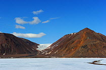 Pack ice, with the moutains and glacier of Brume Point in the background, Ellesmere Island, Nunavut, Canada, June 2012.