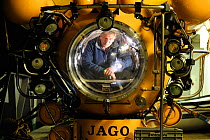 Man looking out of view port of the German research submersible JAGO, aboard the RV POSEIDON, September 2011, editorial use only. Photo taken in cooperation with GEOMAR coldwater coral research projec...