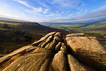 Curbar Edge, a gritstone escarpment and view over valley in early morning light. Peak District National Park, UK, March 2008.
