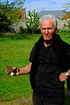 Man holding Common morel fungus (Morchella esculenta) Alsace, France, Model released, April 2012
