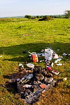 Camping rubbish strewn over common, North Gower, Wales, UK, June 2009