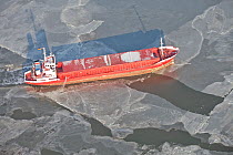 Ship breaking through sea ice. North Sea, Wadden Sea, Germany, February 2012.