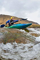 Kayaker in the River Etive, Highlands, Scotland, UK, April 2012.