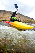 Kayaker on the River Etive, Highlands, Scotland, UK, April 2012.
