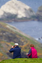 People watching Gannet (Sula bassana) colony. Hermaness National Nature Reserve, Shetland, Scotland.