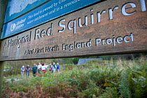 Red Squirrel sign and children on activities as part of Flora of the Fells conservation day. Helvellyn, Lake District National Park, Cumbria, September.