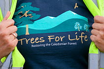 Woman proudly displaying their 'Trees for Life' t-shirt. Scotland.