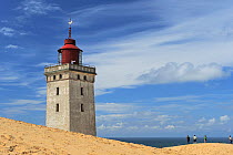 Rubjerg Knude Lighthouse with people on sand dunes, Denmark, July 2009