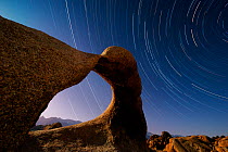 Star trails in sky over Alabama Hills, BLM eroded granite formation know as Mobius Arch. Eastern Sierra, California. May 2012.